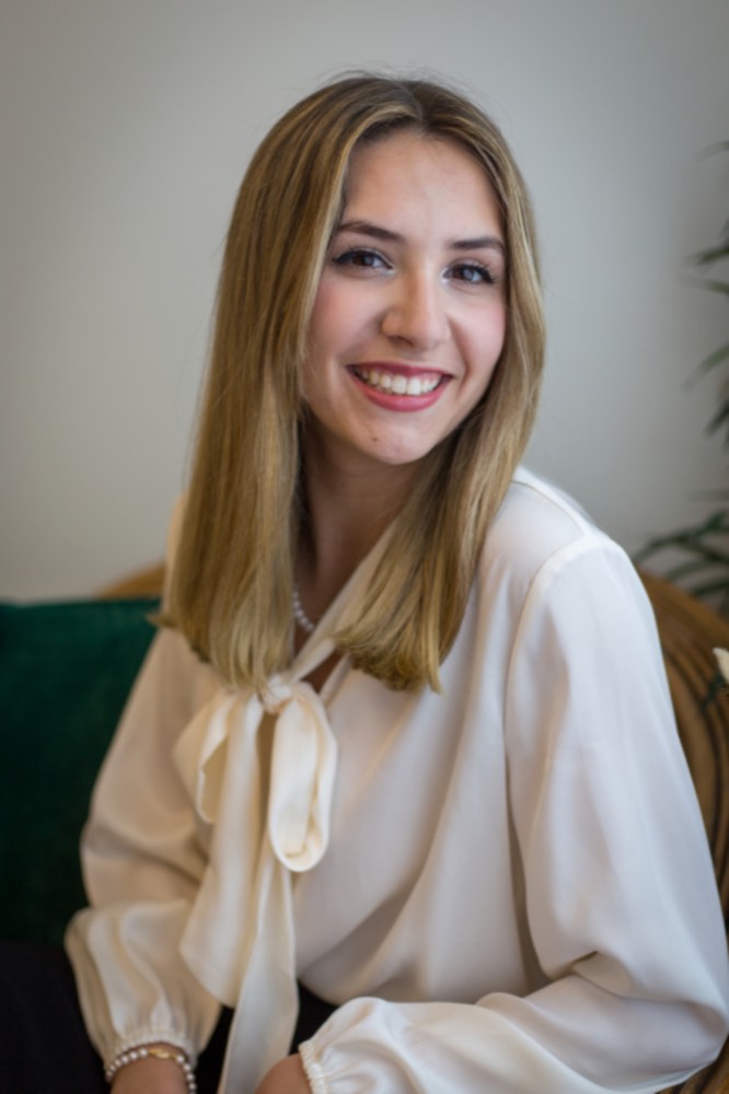 Smiling woman in a white blouse